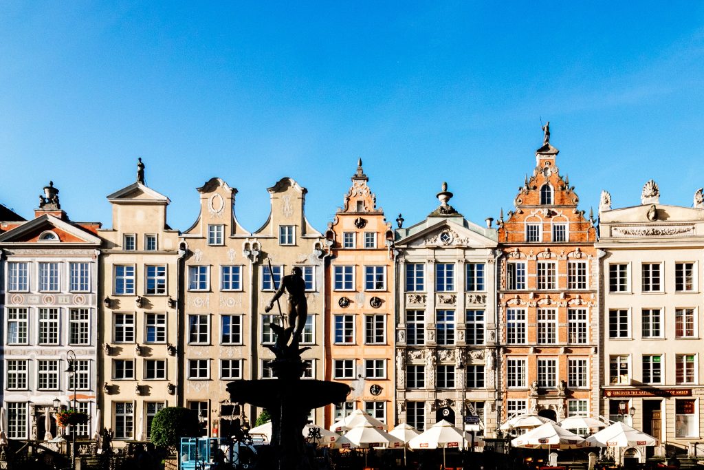 statue with eastern european buildings